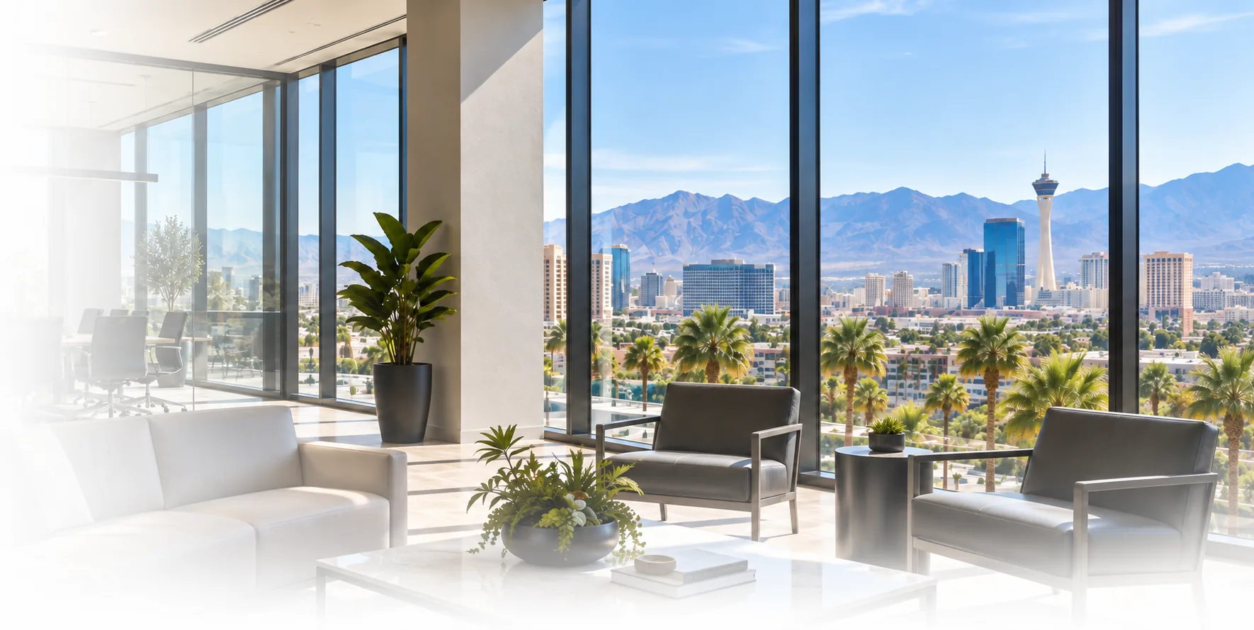 Commercial office interior with floor-to-ceiling windows overlooking the Las Vegas skyline
